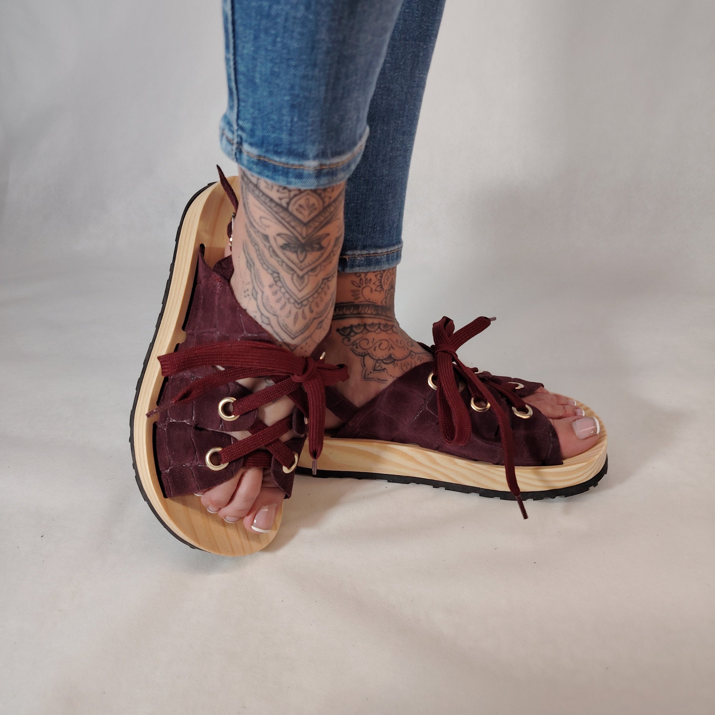 Sandalias de plataforma de madera natural artesanal con tira trasera y pala de piel efecto croco color burdeos y cordones 